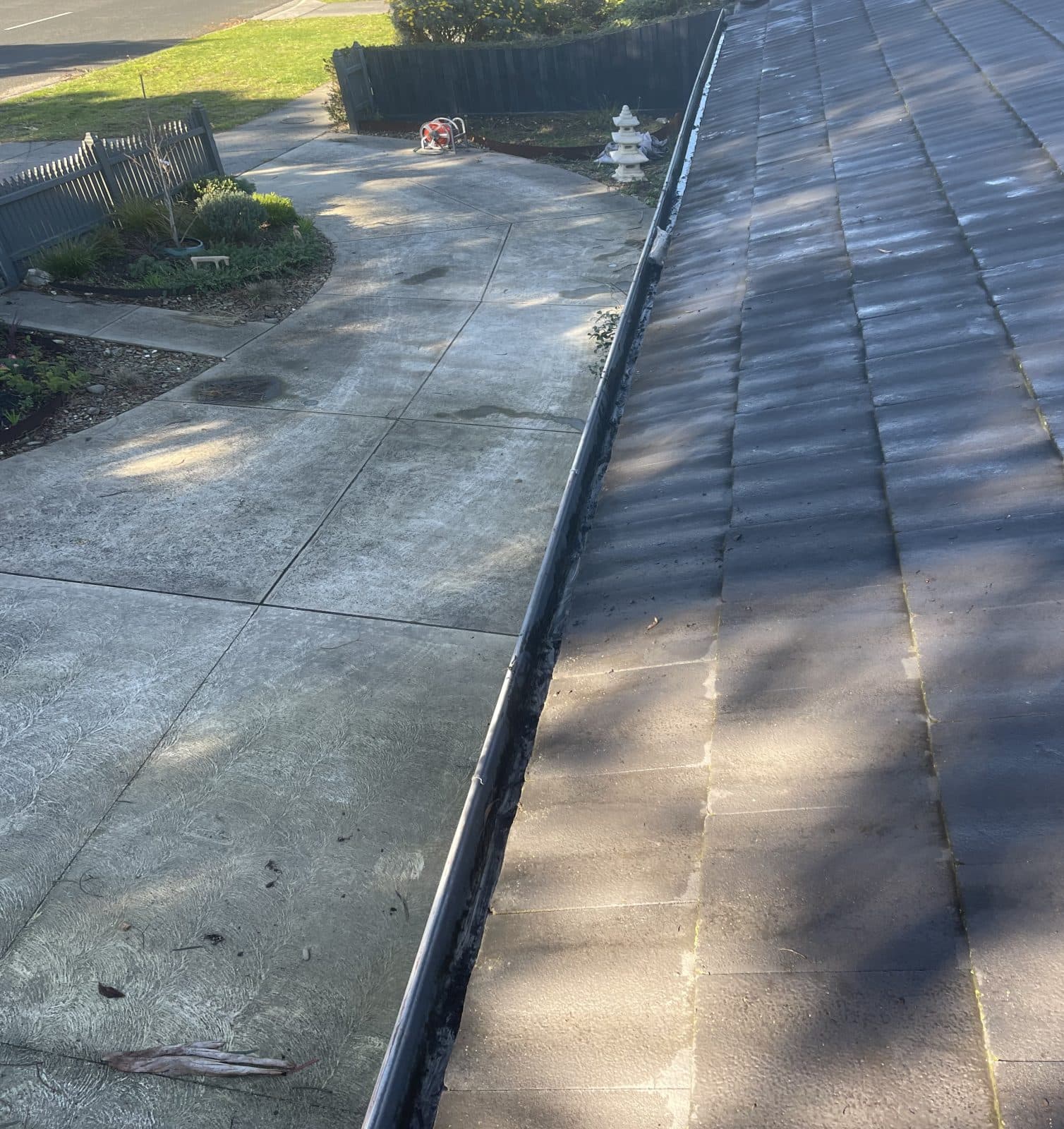 The same gutter run after the Clearline service — the channel clear end to end and the roofline free of debris